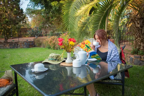 Guest taking afternoon tea in the garden