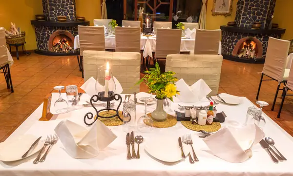 Dinner table with candles and folded napkins