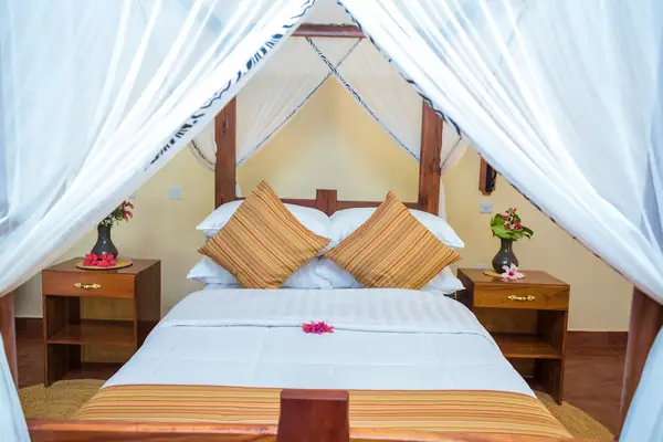 Ruaha Rondavel double bed under a white canopy
