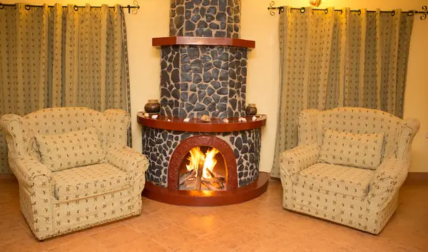 Family House lounge with a round stone fireplace